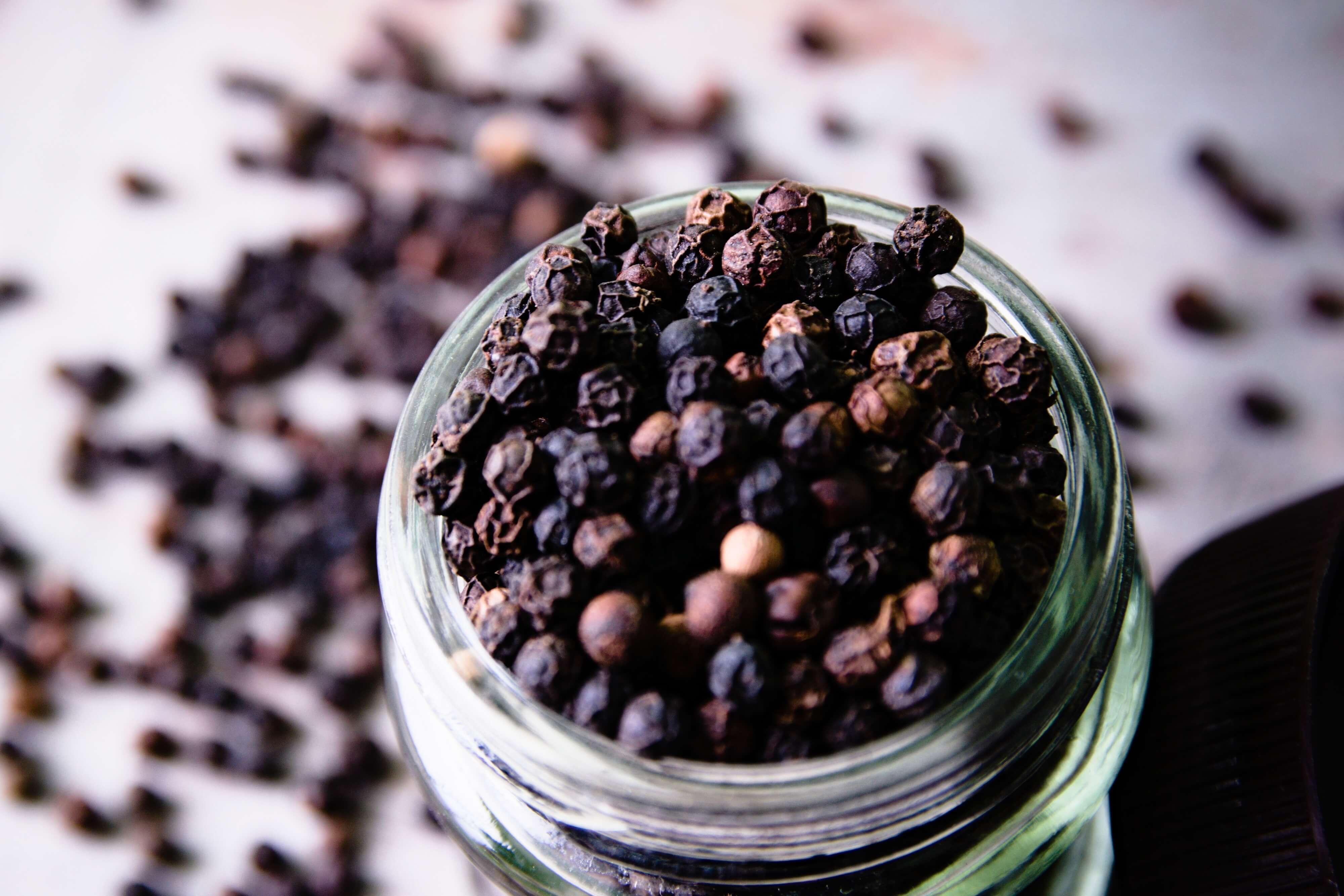 black peppercorns in a jar