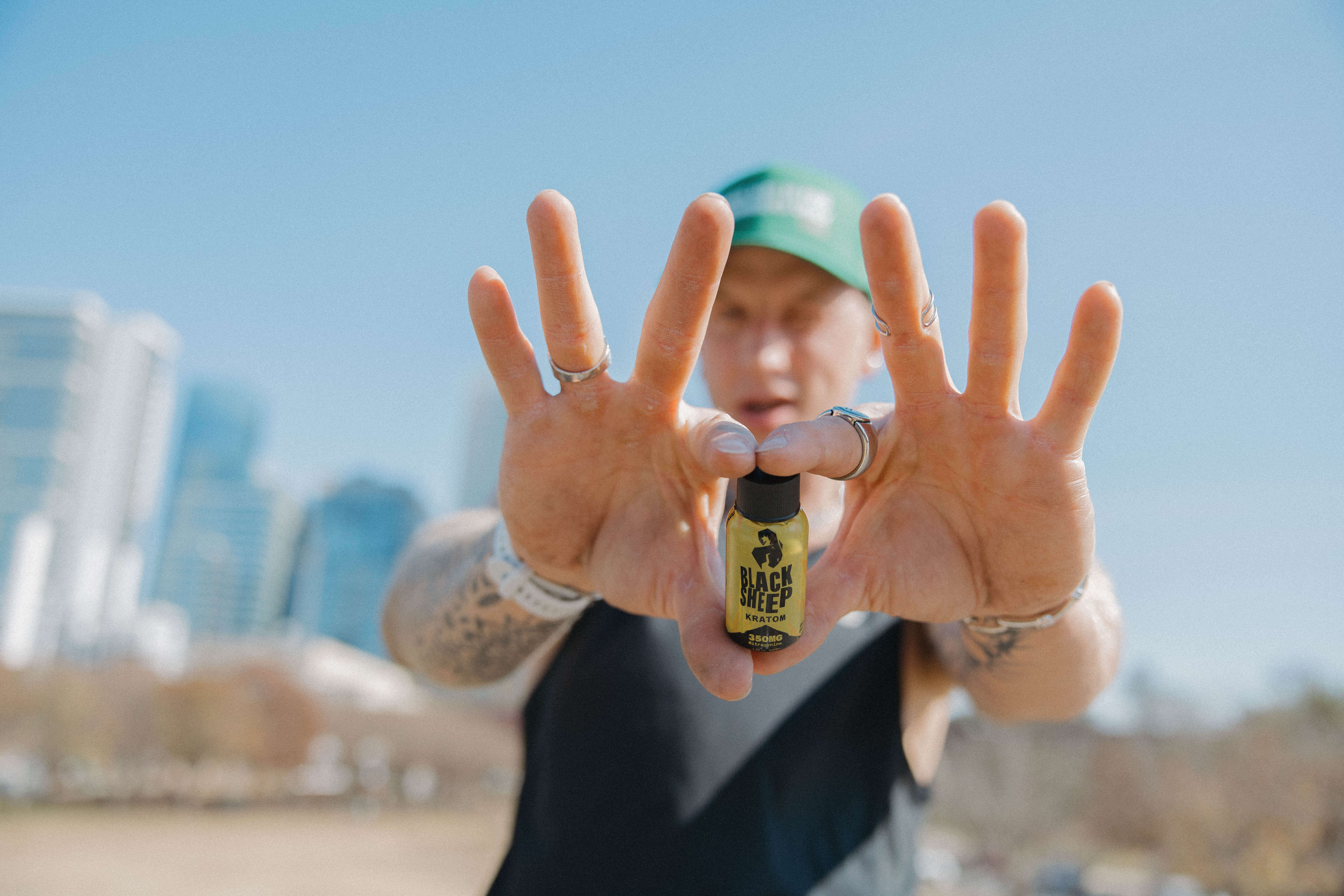 man holding kratom shot