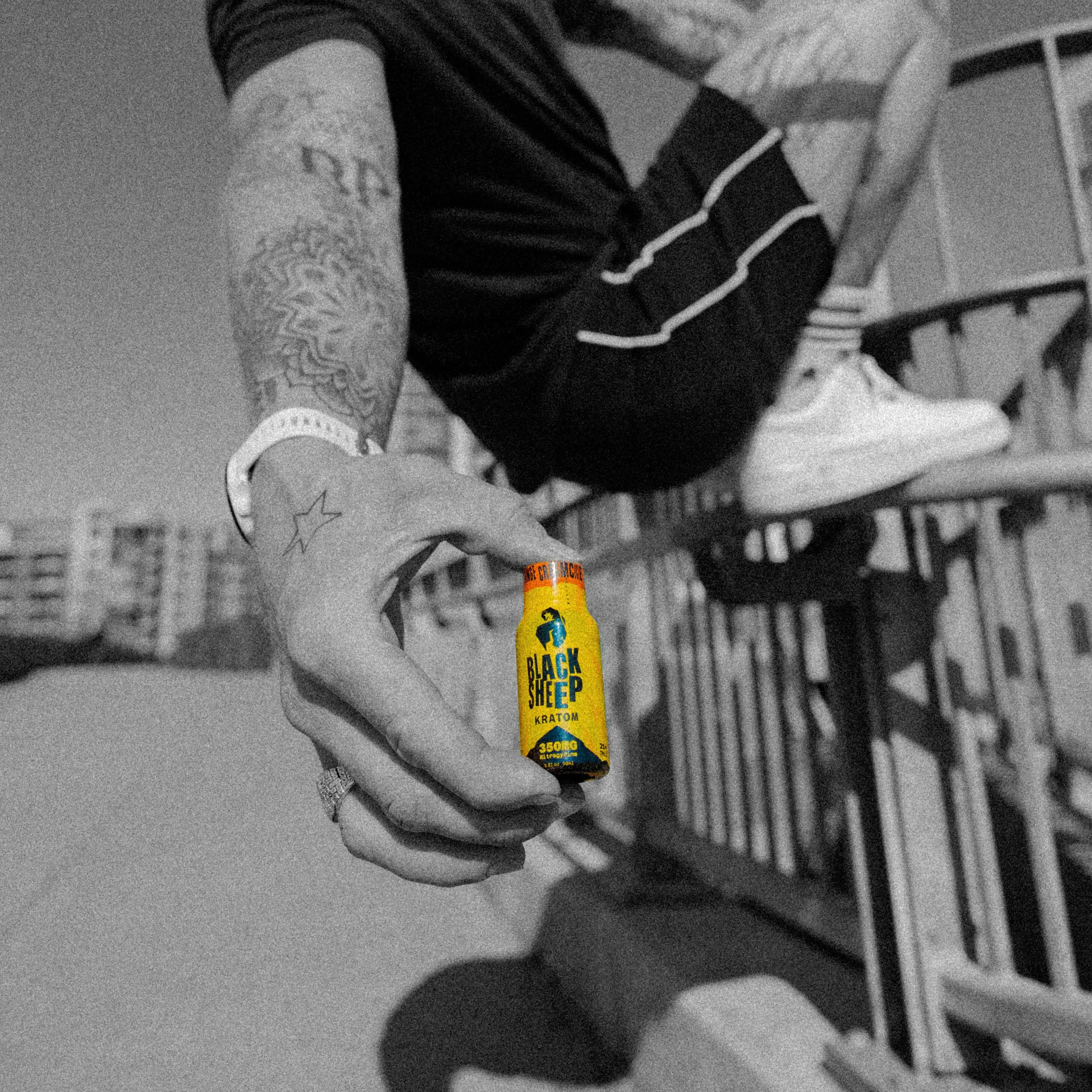man holding kratom shot