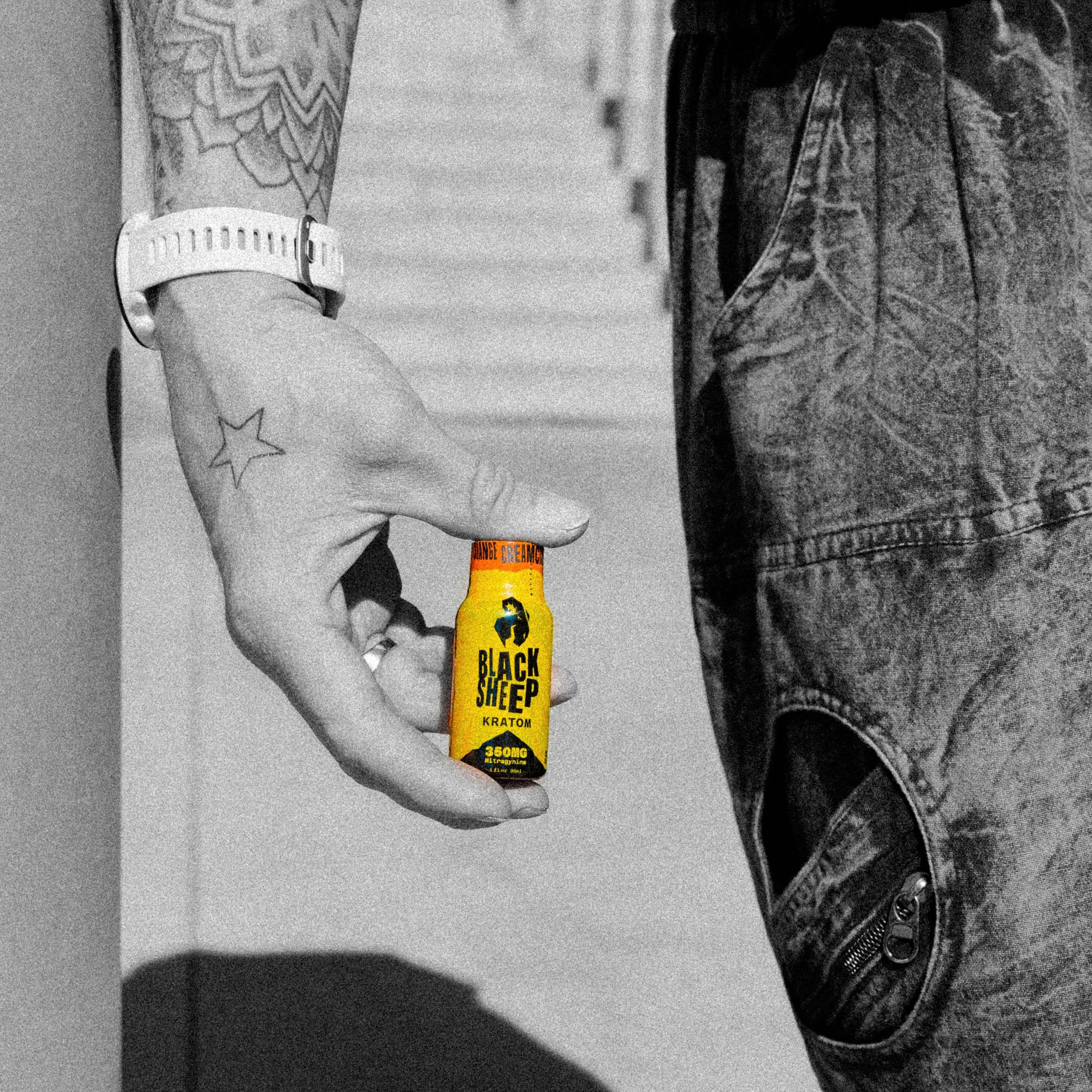 man holding kratom shot