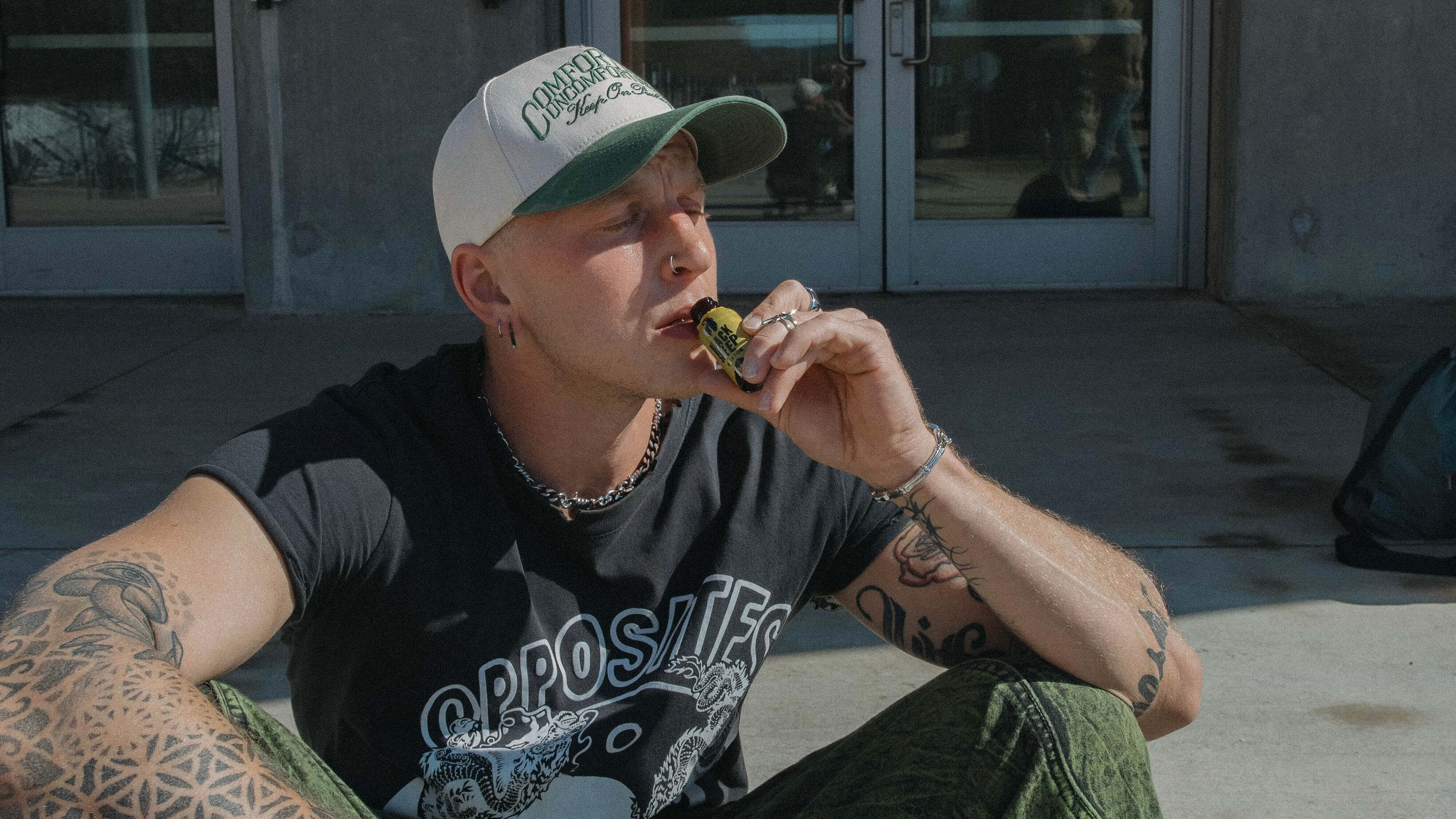 man sipping a kratom shot